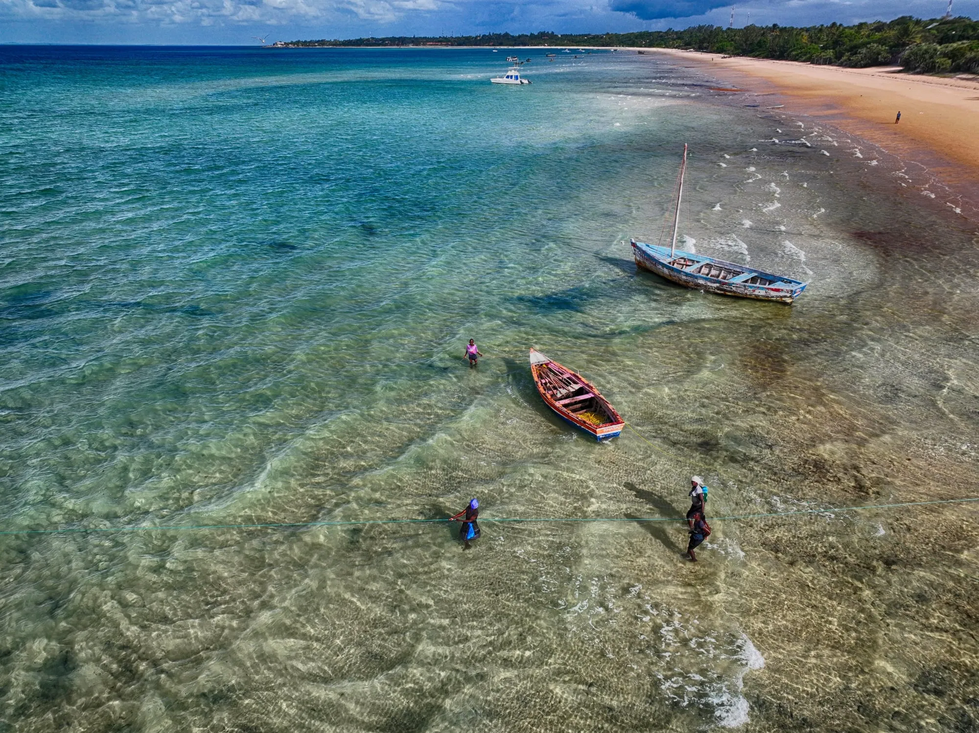 Aerial view of swimmers in the turquoise sea at Vilanculos